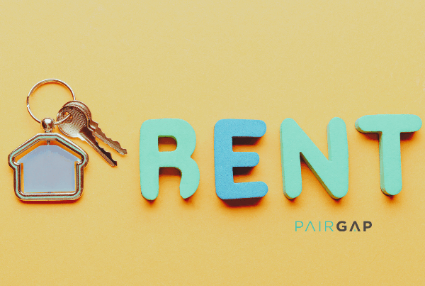 House keys and the word RENT symbolizing that rent is the most expensive thing you’ll never own.