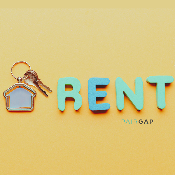House keys and the word RENT symbolizing that rent is the most expensive thing you’ll never own.