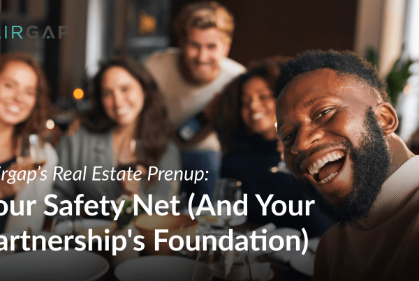 A smiling man takes a selfie at a dinner table with a diverse group of friends in the background, alongside the Pairgap logo and text promoting Pairgap’s Real Estate Prenup.
