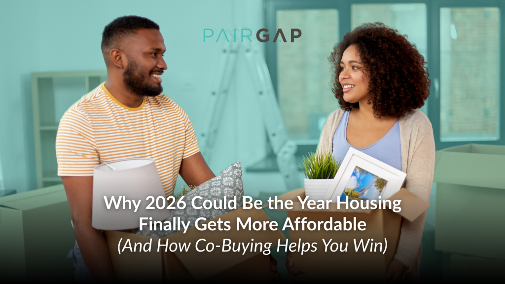 Two prospective homebuyers holding moving boxes and home items while talking, representing shared homeownership and co-buying as a path to affordable housing.