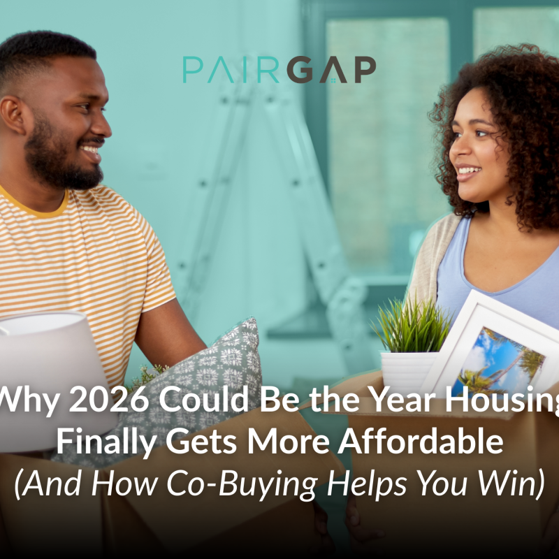 Two prospective homebuyers holding moving boxes and home items while talking, representing shared homeownership and co-buying as a path to affordable housing.