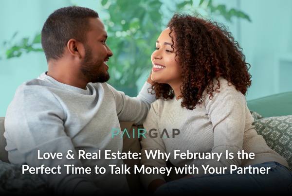 Couple sitting together on a couch smiling at each other while discussing their future home and finances