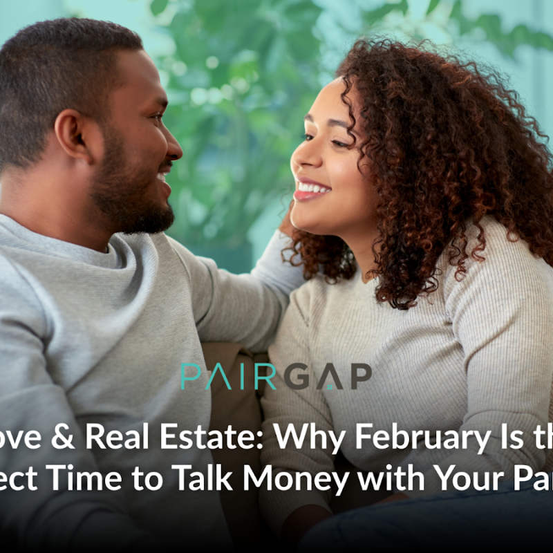 Couple sitting together on a couch smiling at each other while discussing their future home and finances