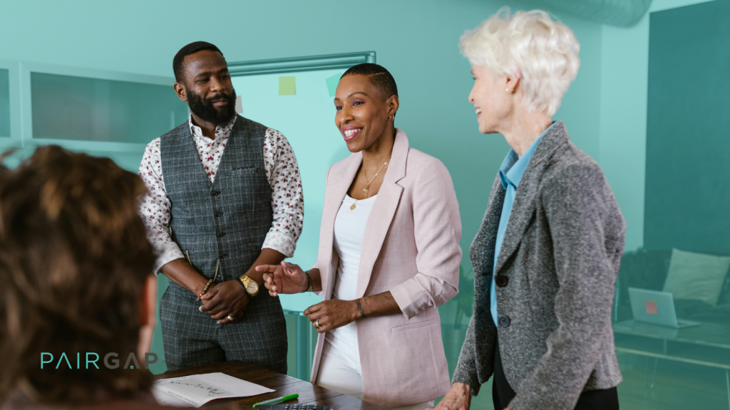 Two real estate investors reviewing property documents and a co-investment agreement at a desk in Q1