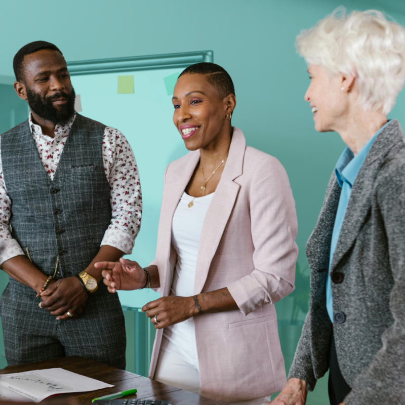 Two real estate investors reviewing property documents and a co-investment agreement at a desk in Q1