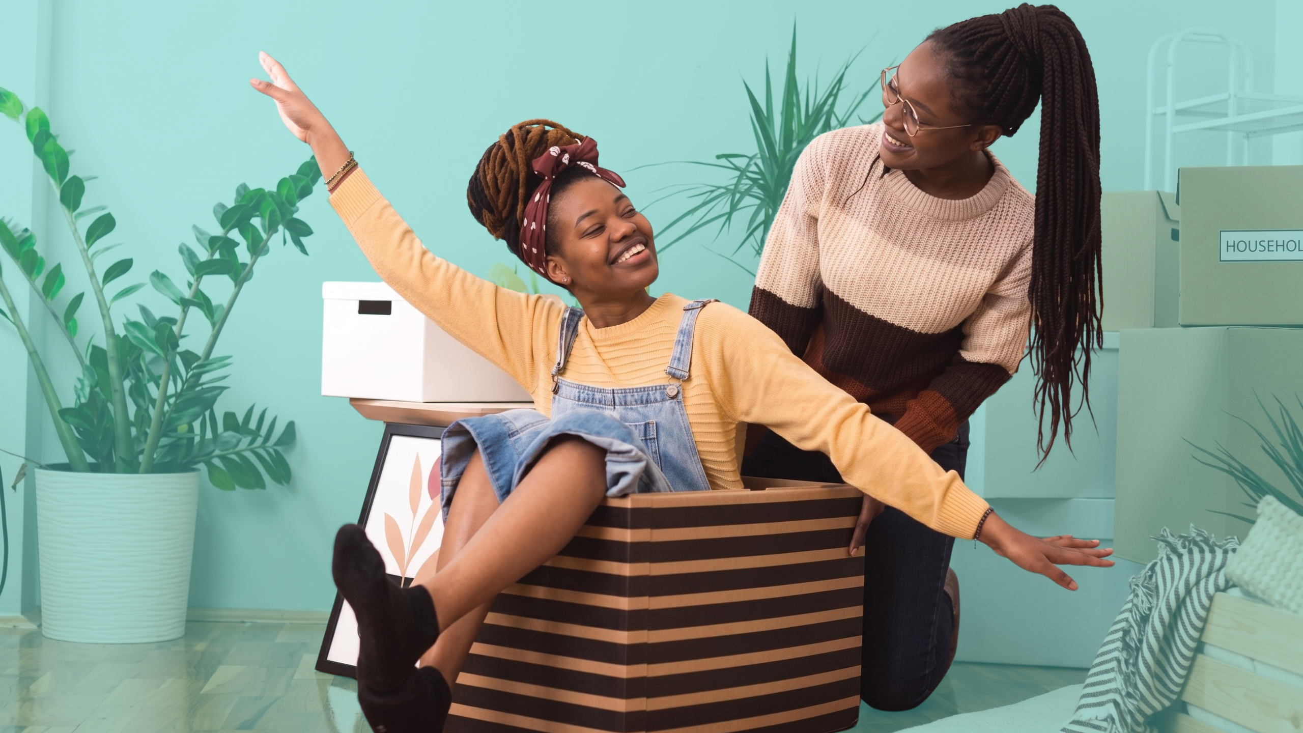 Two friends celebrating in their new home after choosing to co-buy a house together through shared homeownership