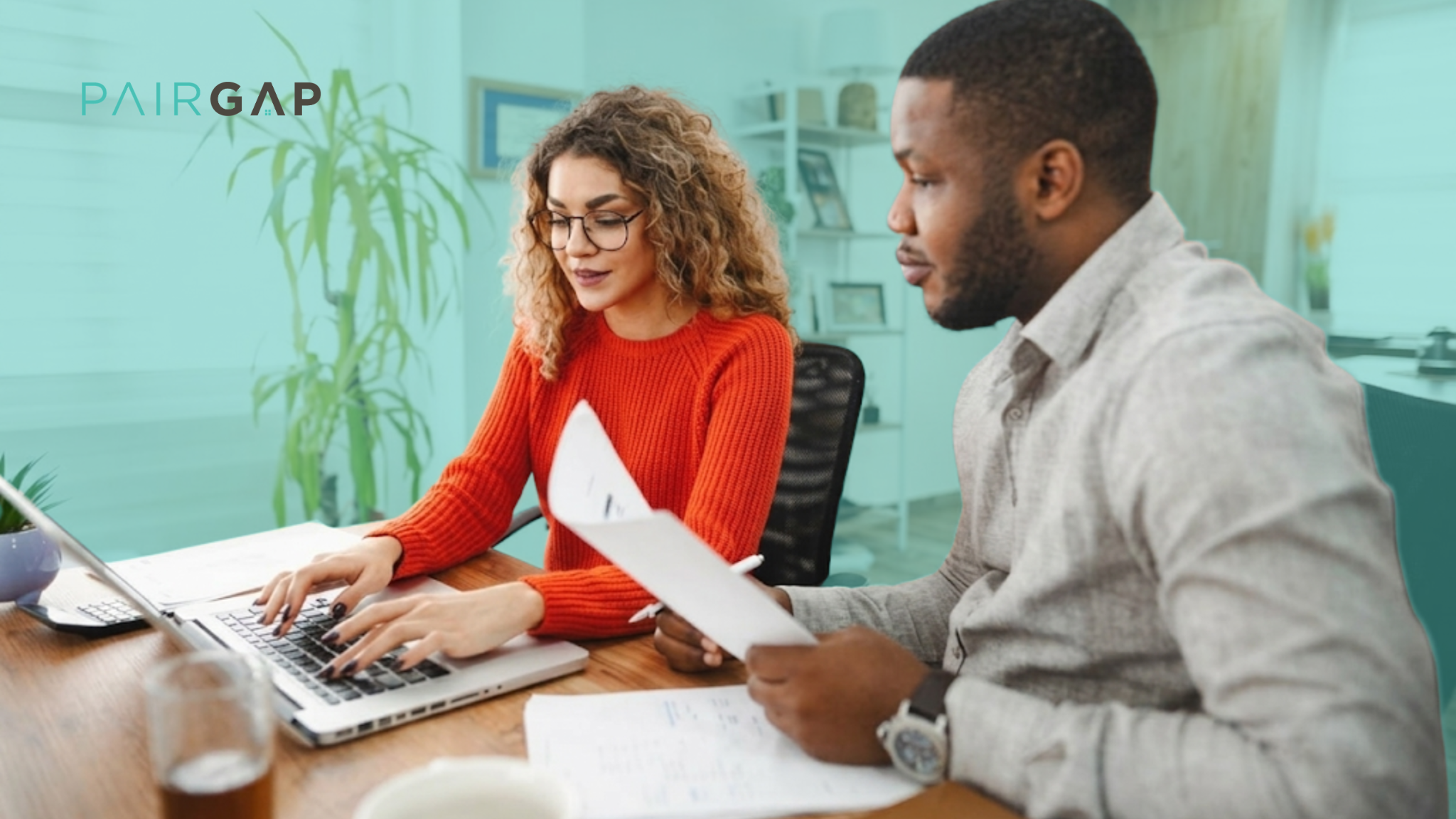 Two co-investors reviewing real estate documents together at a desk with a laptop, with the Pairgap logo in the top left corner.