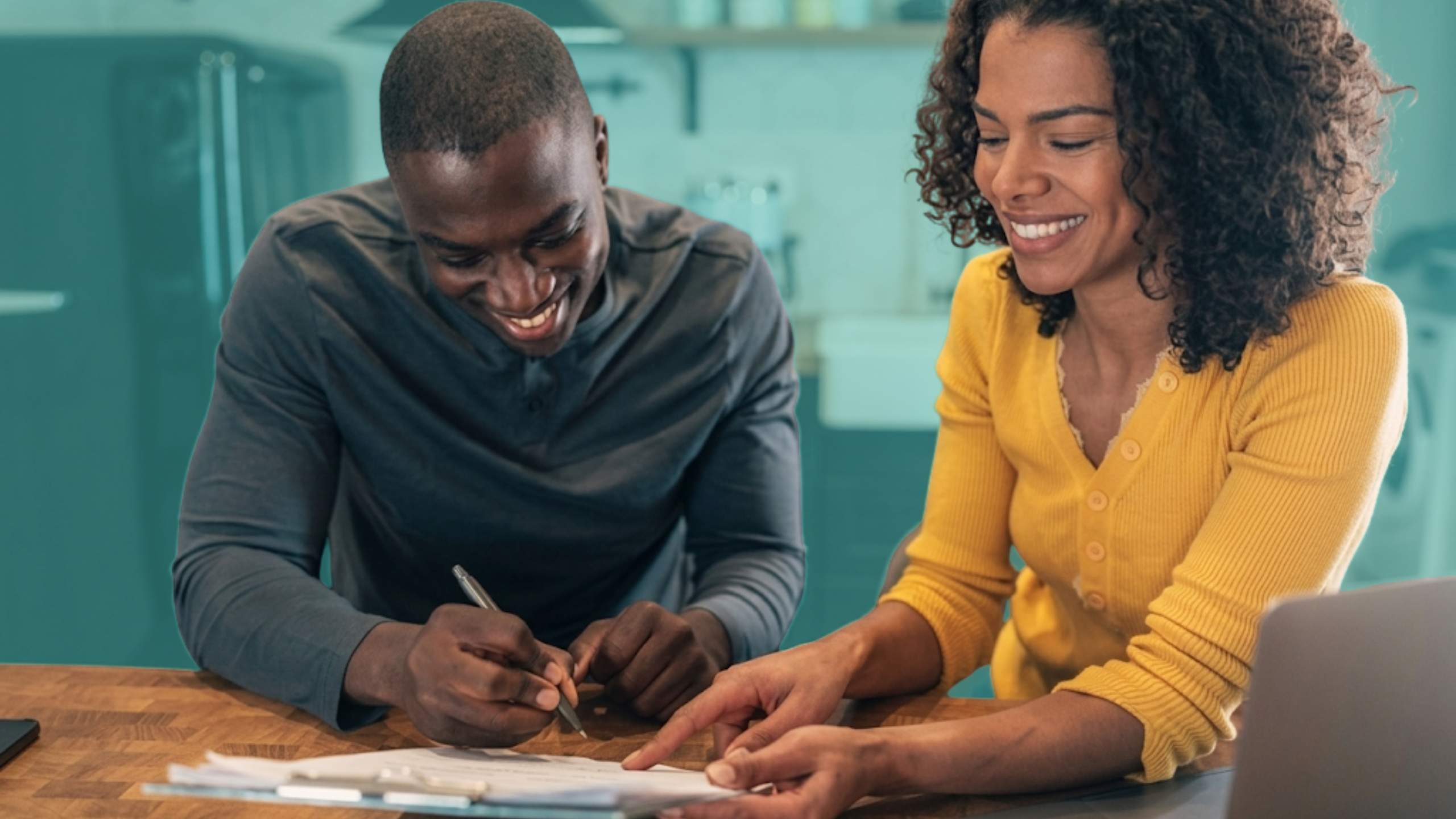 Friends reviewing homeownership documents and discussing a co-buying agreement before purchasing a home together.