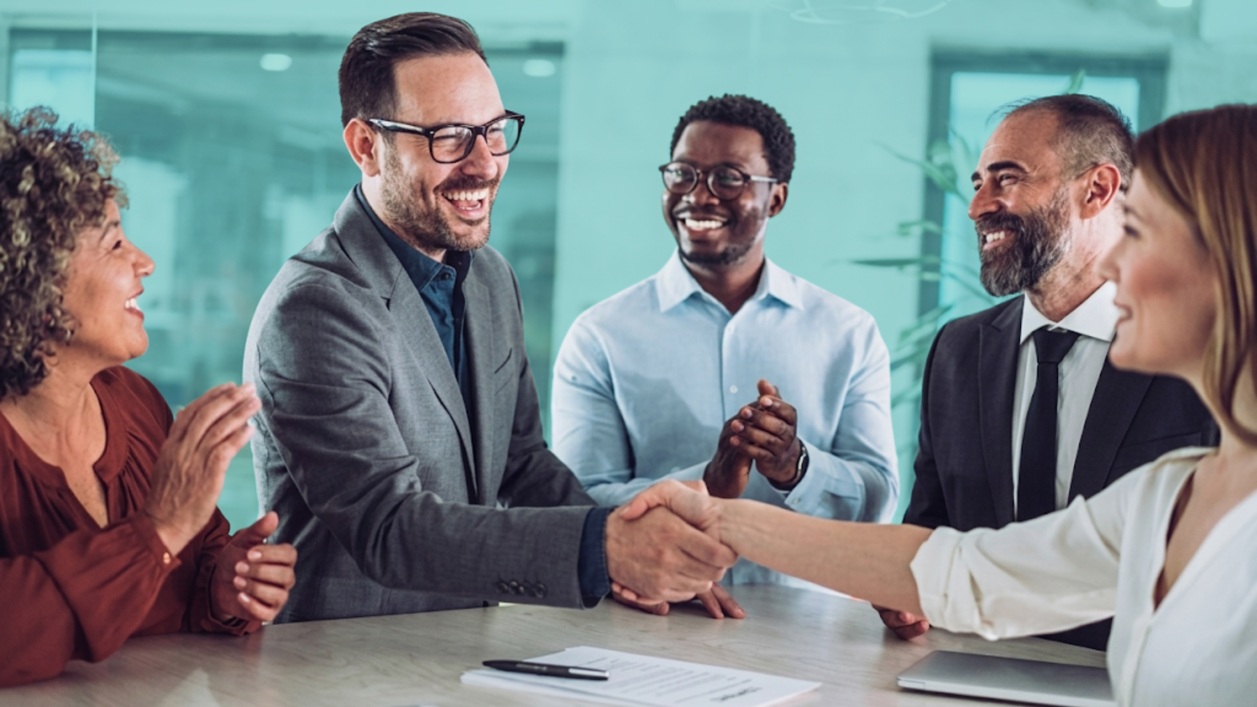 Real estate investment partners shaking hands after discussing a shared property deal, representing co-investing and partnership agreements.