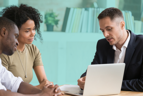 Two prospective co-buyers meeting with a real estate professional to discuss finances, compatibility, and plans for buying a home together.