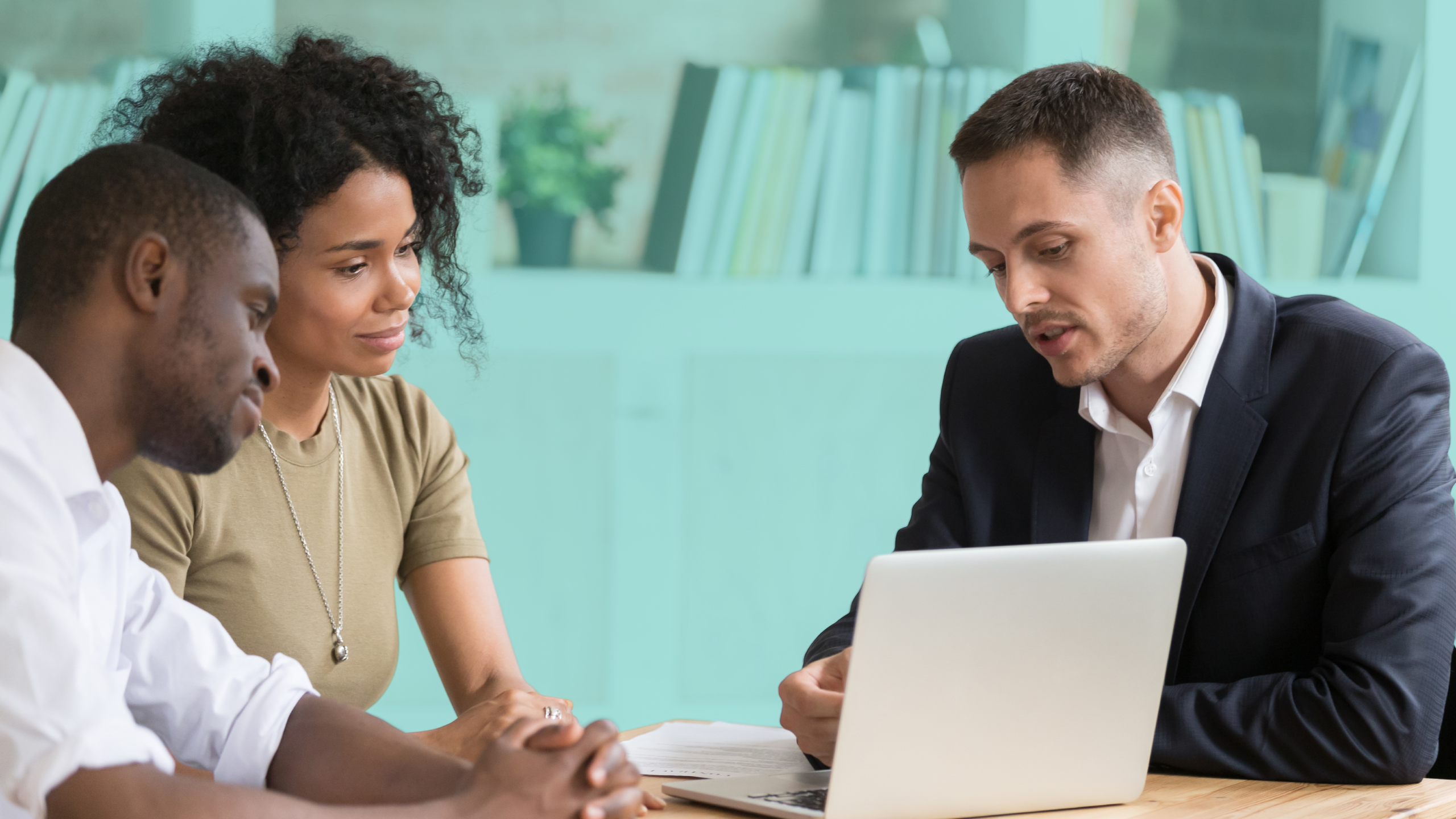 Two prospective co-buyers meeting with a real estate professional to discuss finances, compatibility, and plans for buying a home together.