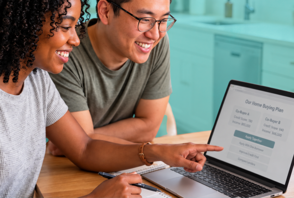 Two friends reviewing combined savings, down payment assistance options and mortgage plans before buying a home together