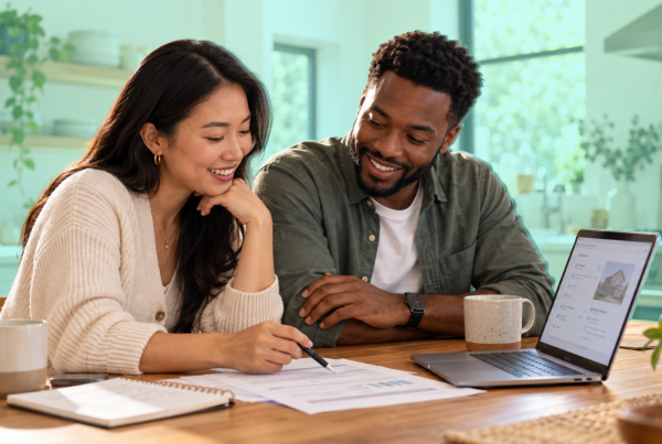 Two co-buyers reviewing homeowners insurance coverage, ownership percentages and shared premium responsibilities before closing